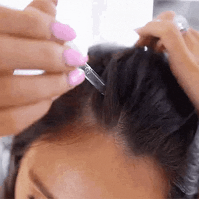 Pregnant woman massaging Hair She Is Hair Serum into scalp for postpartum hair regrowth