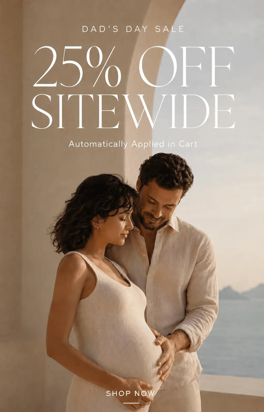 Father's Day Sale promotion featuring an expectant couple standing together in a luxury coastal setting. Text overlay reads "Dad's Day Sale, 25% Off Sitewide, Automatically Applied in Cart" with a Shop Now call-to-action. Warm neutral tones and premium editorial maternity lifestyle photography.