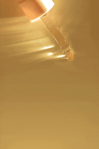 Dropper applying Hair She Is Hair Serum to scalp – lightweight pregnancy hair growth serum