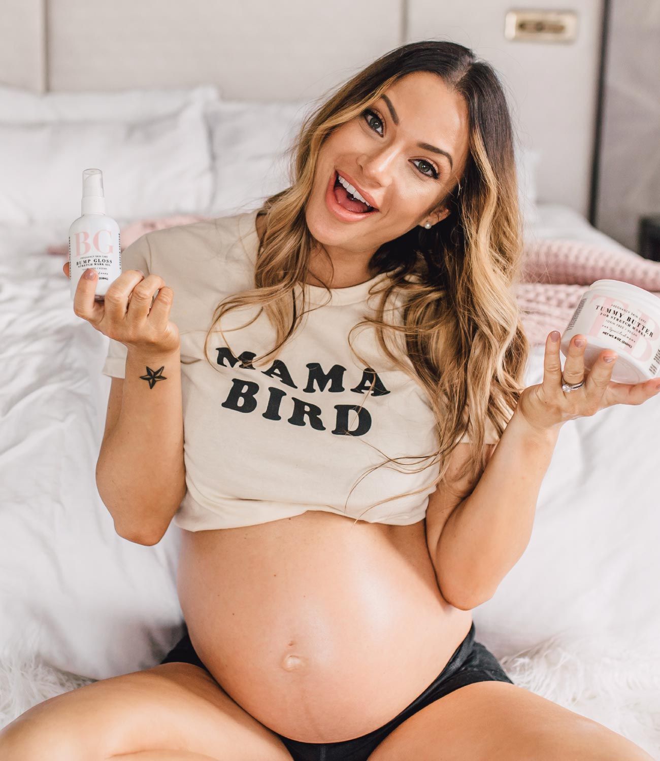 Pregnant woman holding Bump Gloss and Tummy Butter while building a personalized pregnancy skincare bundle.