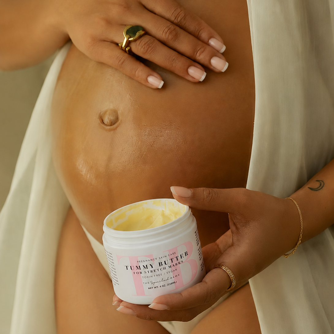 Pregnant woman holding a jar of 'Tummy Butter' against a light background