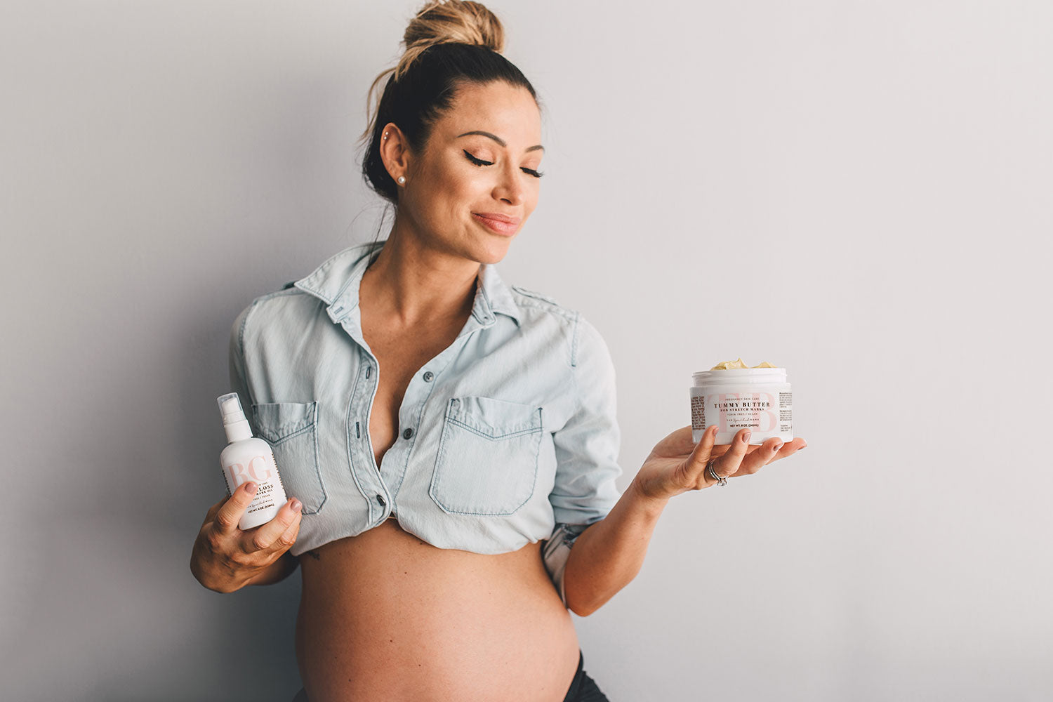 Woman holding The Spoiled Mama pregnancy skincare products while taking the pregnancy skincare routine quiz.