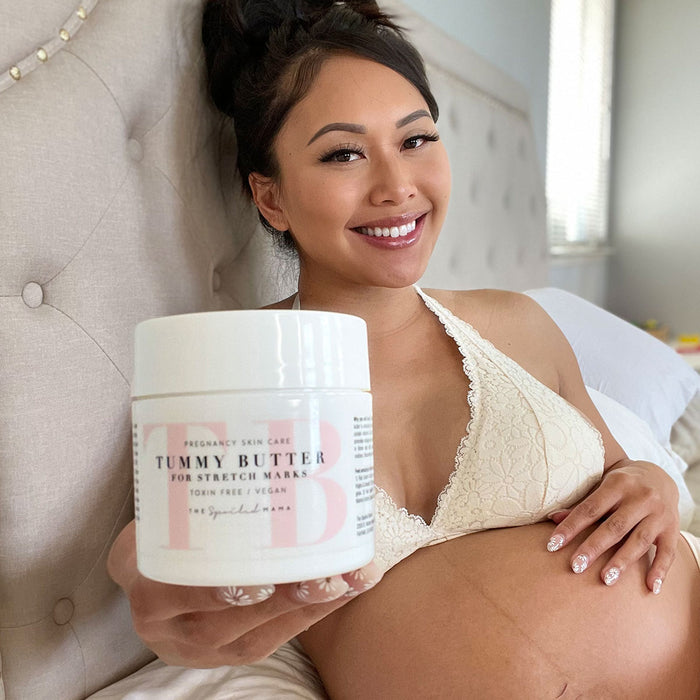 Pregnant woman holding The Spoiled Mama Tummy Butter for Stretch Marks, a deeply moisturizing pregnancy body butter that nourishes dry, stretching skin during pregnancy and postpartum.